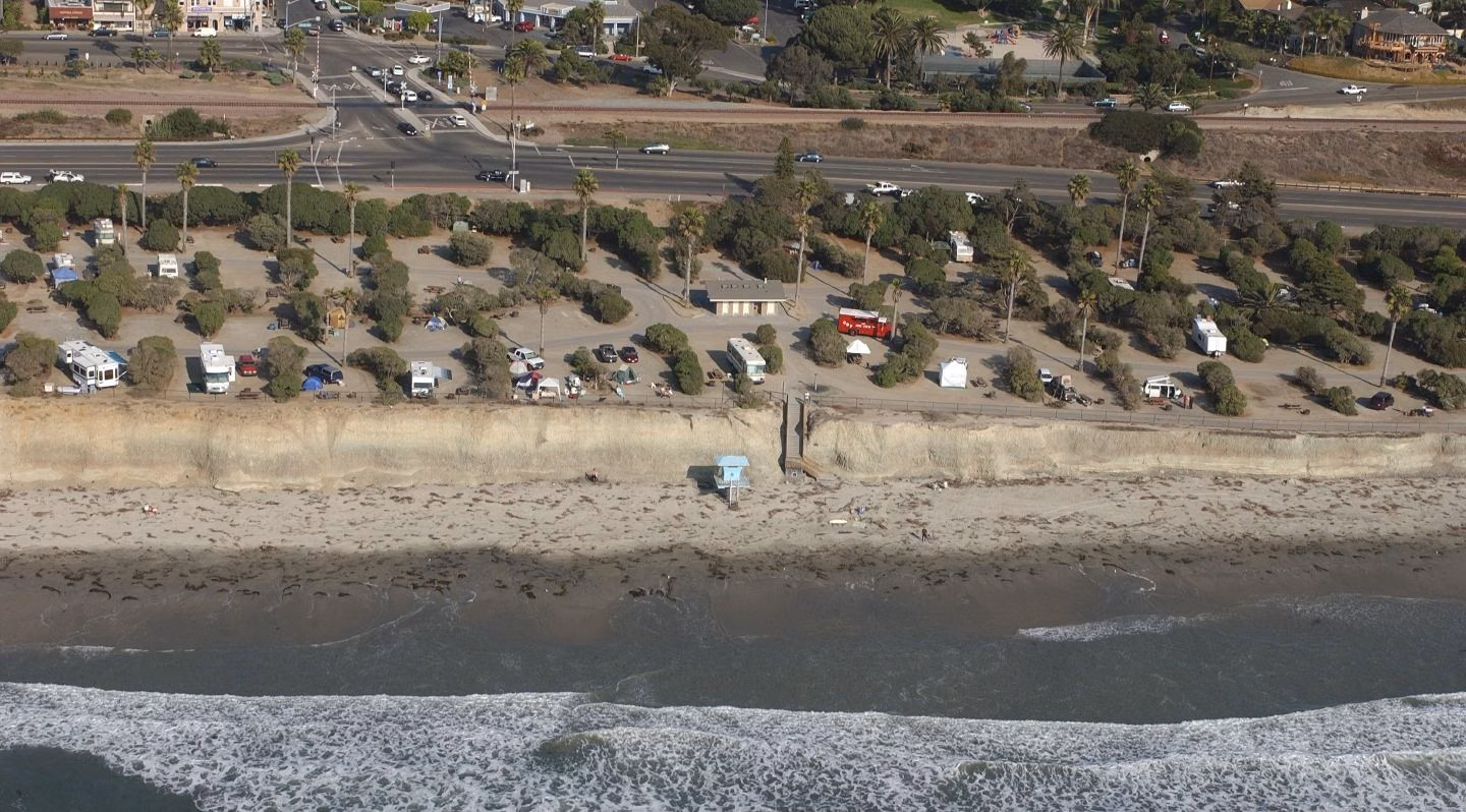 San Elijo State Beach campground on the bluff, with campers and RVs in sites above the beach